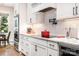 Modern kitchen with white cabinets, stainless steel appliances, and tile backsplash at 4033 Hilton Lake Rd, Kannapolis, NC 28083