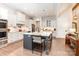 Bright kitchen featuring white cabinets, a granite island with seating, and stainless steel appliances at 4033 Hilton Lake Rd, Kannapolis, NC 28083