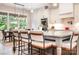 Bright kitchen island with seating, pendant lighting, and a view of the adjacent dining area at 4033 Hilton Lake Rd, Kannapolis, NC 28083