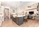 Open kitchen featuring an island with seating, stainless appliances, and a view into the living room at 4033 Hilton Lake Rd, Kannapolis, NC 28083