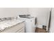 This laundry room has side-by-side, front-loading washer and dryer, with counter space above at 4033 Hilton Lake Rd, Kannapolis, NC 28083