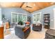 Bright sunroom with vaulted wood ceilings and walls of windows overlooking the landscape at 4033 Hilton Lake Rd, Kannapolis, NC 28083