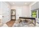 Office space with desk and seating with wood floors, white walls, and natural light at 4033 Hilton Lake Rd, Kannapolis, NC 28083