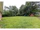 A large, grassy backyard offers plenty of space and features a storage shed at 6421 Hidden Forest Dr, Charlotte, NC 28213