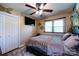 Cozy bedroom features a ceiling fan, a window for natural light, and a closet at 6421 Hidden Forest Dr, Charlotte, NC 28213