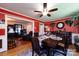 Charming dining room showcasing a wooden table, decorative accents, and bright red walls at 6421 Hidden Forest Dr, Charlotte, NC 28213