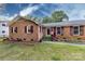 Charming brick home featuring a well-manicured lawn, colorful landscaping, and complementary colored shutters and front door at 6421 Hidden Forest Dr, Charlotte, NC 28213