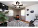 Cozy living room with stone accent wall, tv, ceiling fan, and hardwood floors at 6421 Hidden Forest Dr, Charlotte, NC 28213