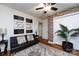 Inviting living room with hardwood floors, a futon, and a decorative stone wall at 6421 Hidden Forest Dr, Charlotte, NC 28213
