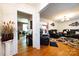 Cozy living room featuring wood floors, fresh paint, recessed lighting, and an open access to the dining and kitchen area at 6421 Hidden Forest Dr, Charlotte, NC 28213