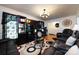 Inviting living room featuring a modern entertainment center and comfortable leather seating at 6421 Hidden Forest Dr, Charlotte, NC 28213
