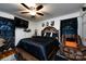 Spacious main bedroom features a ceiling fan, tv, and a sitting chair at 6421 Hidden Forest Dr, Charlotte, NC 28213