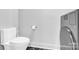 Modern bathroom features a sleek toilet and combination washer/dryer with dark accent tiles at 715 N Graham St # 207, Charlotte, NC 28202