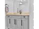 Elegant bathroom boasts a marble countertop, sleek gray cabinetry, modern fixtures, and ample counter space at 715 N Graham St # 207, Charlotte, NC 28202