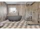Beautiful bathroom features modern tiling, soaking tub, and glass shower door at 715 N Graham St # 207, Charlotte, NC 28202