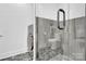 The bathroom features a modern, grey-tiled shower, sleek fixtures, and a convenient washer/dryer combo unit at 715 N Graham St # 207, Charlotte, NC 28202