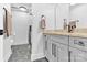 Elegant bathroom boasts a marble countertop, sleek gray cabinetry, modern fixtures, and a stylish glass shower at 715 N Graham St # 207, Charlotte, NC 28202