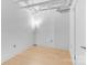 Bright bedroom with hardwood floors, modern lighting, and exposed ceiling pipes at 715 N Graham St # 207, Charlotte, NC 28202