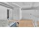 Modern bedroom with hardwood floors, a stylish bed, exposed ductwork, and bright natural light, ideal for urban living at 715 N Graham St # 207, Charlotte, NC 28202