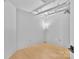 Bright bedroom with hardwood floors, modern lighting, and exposed ceiling pipes at 715 N Graham St # 207, Charlotte, NC 28202