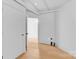 Modern bedroom with hardwood floors and unique, industrial-style exposed ceiling pipes at 715 N Graham St # 207, Charlotte, NC 28202