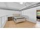 Modern bedroom with hardwood floors, a stylish bed, exposed ductwork, and bright natural light, ideal for urban living at 715 N Graham St # 207, Charlotte, NC 28202