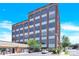 Exterior daytime view of a brick multi-story building with large windows and a blue sky at 715 N Graham St # 207, Charlotte, NC 28202