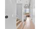 Hallway featuring hardwood floors, stairs, natural light, and a view to the kitchen at 715 N Graham St # 207, Charlotte, NC 28202