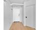 Bright hallway with hardwood floors, and two doors at 715 N Graham St # 207, Charlotte, NC 28202