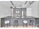 Modern kitchen features an island with barstool seating and stainless steel appliances at 715 N Graham St # 207, Charlotte, NC 28202