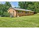 Expansive backyard featuring lush green grass and a well-maintained brick home at 7753 Caswell Rd, Stanley, NC 28164