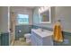 Bathroom with a white vanity, tiled floors, and a window for natural light at 7753 Caswell Rd, Stanley, NC 28164
