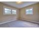 Bright carpeted bedroom features two windows offering natural light at 7753 Caswell Rd, Stanley, NC 28164