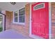 Inviting red front door with brick surround, offering a warm welcome to the home at 7753 Caswell Rd, Stanley, NC 28164