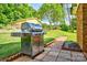 Outdoor grill area with a stainless steel gas grill and brick-lined pathway at 7753 Caswell Rd, Stanley, NC 28164