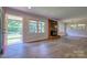 Open living room area with a brick fireplace and large windows providing natural light at 7753 Caswell Rd, Stanley, NC 28164