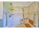 Accessible tiled shower with grab bars and built-in seating at 7753 Caswell Rd, Stanley, NC 28164