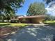 Charming split-level home with a brick facade and covered carport, surrounded by mature trees and a gravel driveway at 12003 Old Beatty Ford Rd, Rockwell, NC 28138