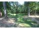 View of the backyard showing the grassy area with mature shade trees and storage building at 1257 Reese Roach Rd, Rock Hill, SC 29730