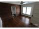 Bedroom with unique wood paneling and hardwood floors; ensuite bathroom visible through doorway at 1257 Reese Roach Rd, Rock Hill, SC 29730