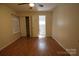 Bedroom featuring two windows, closet, light wood floors, and doorway to a powder room at 1257 Reese Roach Rd, Rock Hill, SC 29730