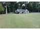 Charming white home featuring a well-maintained front yard and mature trees at 1257 Reese Roach Rd, Rock Hill, SC 29730