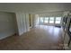 Spacious living room with wood-look floors, closet storage, and multiple windows for natural light at 1257 Reese Roach Rd, Rock Hill, SC 29730