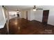 Spacious living room with hardwood floors, ceiling fan, and view into the adjacent eat-in kitchen at 1257 Reese Roach Rd, Rock Hill, SC 29730
