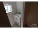 Small powder room featuring a white vanity sink and mirror, with natural light at 1257 Reese Roach Rd, Rock Hill, SC 29730