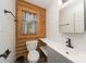 Well-appointed bathroom featuring wooden accent wall, gray vanity, and modern fixtures at 164 Pleasant Creek Dr, Cleveland, NC 27013