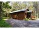 Charming log cabin with a metal roof, complemented by a cozy porch and lush greenery, offering a rustic retreat at 164 Pleasant Creek Dr, Cleveland, NC 27013