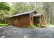 Charming log cabin home with a covered porch nestled among the trees at 164 Pleasant Creek Dr, Cleveland, NC 27013