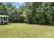 Large grass backyard area featuring open space and wooded area at 222 Laramie Dr, Stanley, NC 28164
