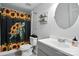 Cozy bathroom featuring a modern vanity and unique turtle and sunflower shower curtain at 222 Laramie Dr, Stanley, NC 28164